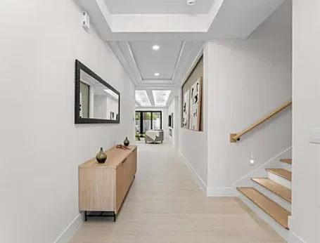 Light-colored flooring through a bright hallway